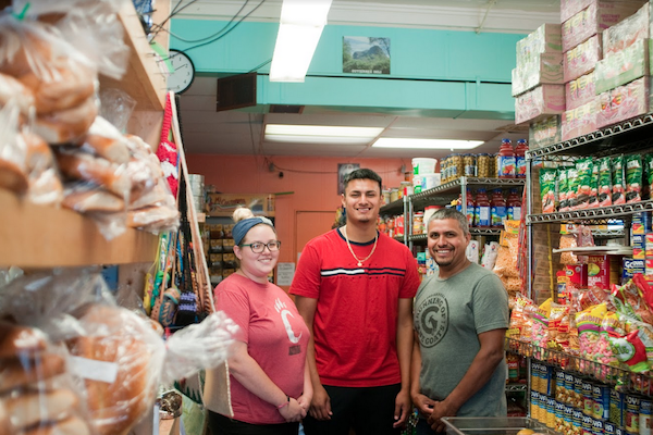 Sergio Gutierrez, center, with a family member and partners.