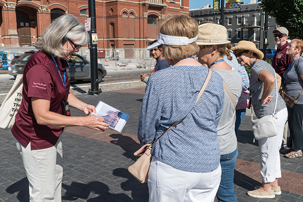 Guide Thea Tjepkema leads a walking tour of Music Hall's exterior.