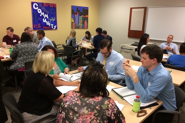 Young professionals put their heads together during the Resource On-the-Rise kickoff.