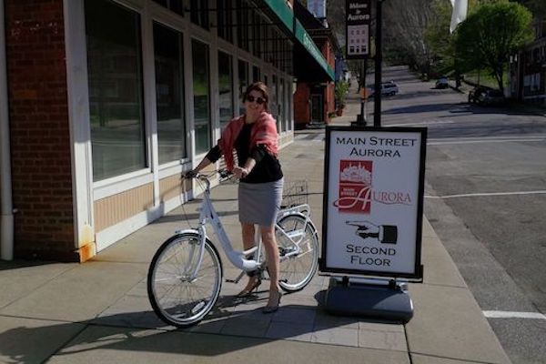 Aurora city manager Guenevere Emery on a bike share bike. 