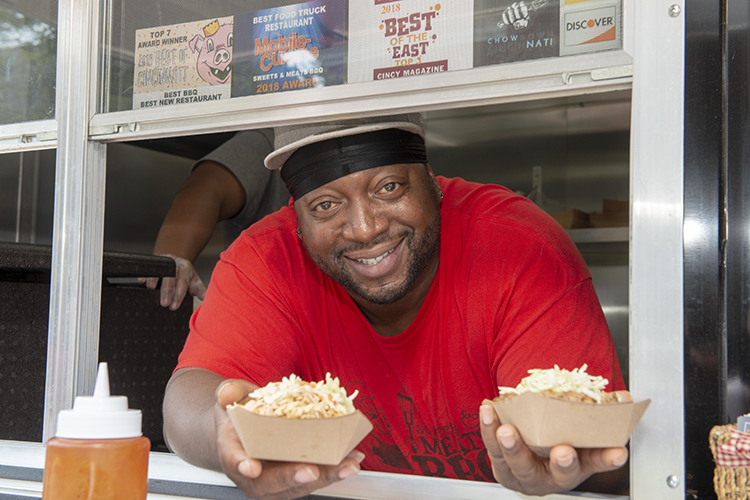 Anton Gaffney serves the chicken and and pork four way.