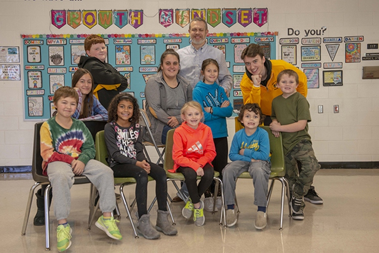 A group of Bellevue students, ranging from elementary school kids through current seniors, along with Bellevue Schools Superintendent Robb Smith.