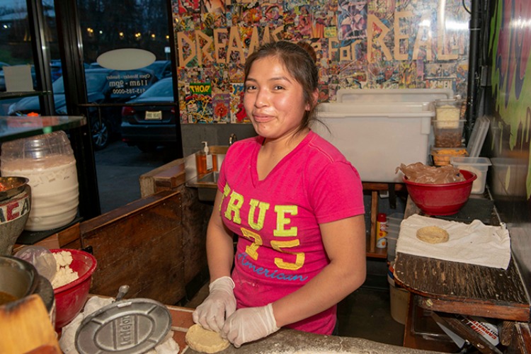 Alvina Morales makes corn tortillas.