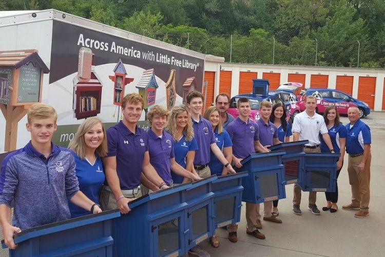 Student volunteers from Elder High School helped unload and store the libraries.