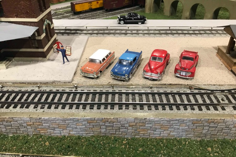 The display includes miniature buildings, people, and cars as well.