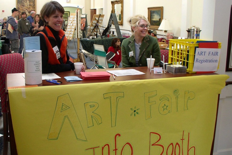 Barb Smucker (left), part of the original leadership team for the fair, greets visitors. 