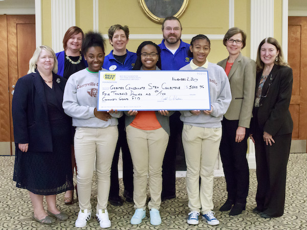 Students from Corryville Catholic School hold a check from Best Buy that will support their 3D printer club.