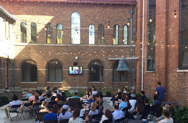 The beer garden style courtyard contains the original St. George's steeple bell at Crossroads Uptown.