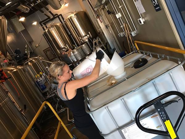 Katrina Eckard, CEO of WEL Enterprises, works on the water reclamation system at Municipal Brew Works.