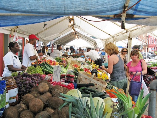 Produce vendors and shoppers inside Findlay Market.