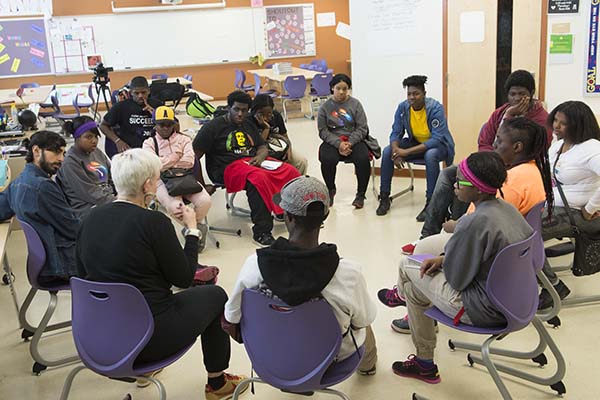 Local spoken word artist Abiyah (white hair, left) coaches students in their final preparation 