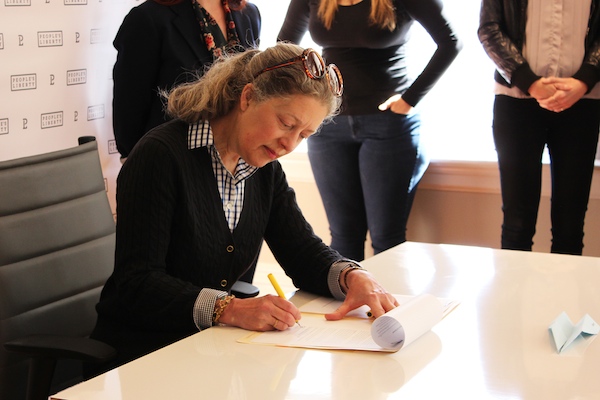 Nancy Sunnenburg signs her Project Grant contract April 24