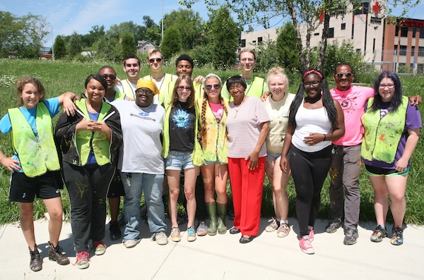 Evanston Community Council President Anzora Adkins (center, red pants) poses with Xavier teaching artist Jordanne Renner (left of Adkins) and ArtWorks apprentices