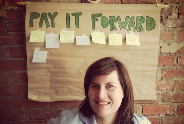 Michelle Dillingham of Community Shares helps the "pay it forward" board