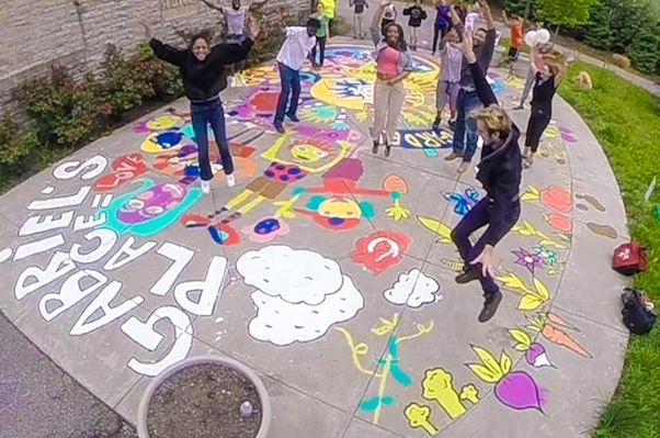 Avondale residents & helpers jump for joy after finishing painting project at Gabriel's Place