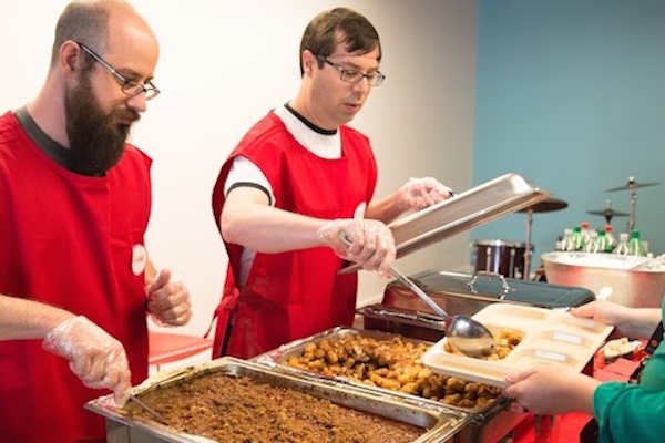 Workers dish out elementary school-style lunches during a Tech Cafeteria event, hosted by Gaslight.