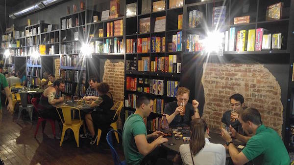 Customers enjoy a draft and something to eat over board games at The Rook OTR.