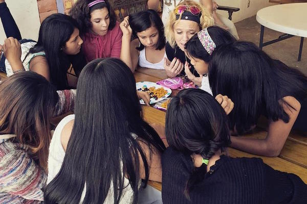 Beth Guckenberger (center) interacts with children on an international service mission.