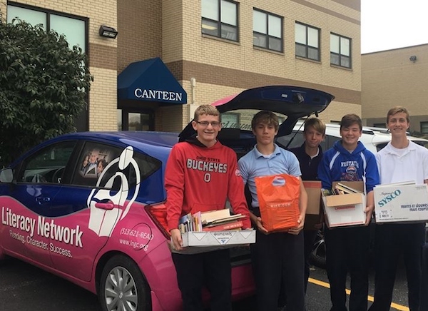 Students from Our Lady of the Visitation load books donated through the school's Read-a-Thon.