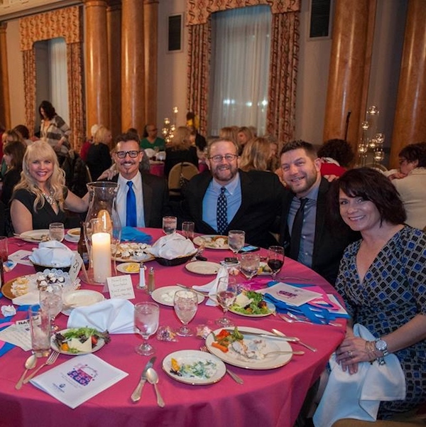 Tim Goldrainer of The Menus and hosts of the B105 Morning Show enjoy dinner before the live auction at last year's event.