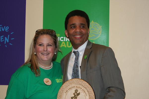 Mary Huttlinger awards Councilmember Christoper Smitherman the Golden Glove award.