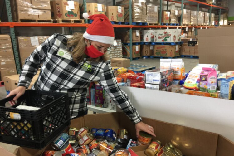 Beth McIntire sorts donations at a GO Pantry food collection event.