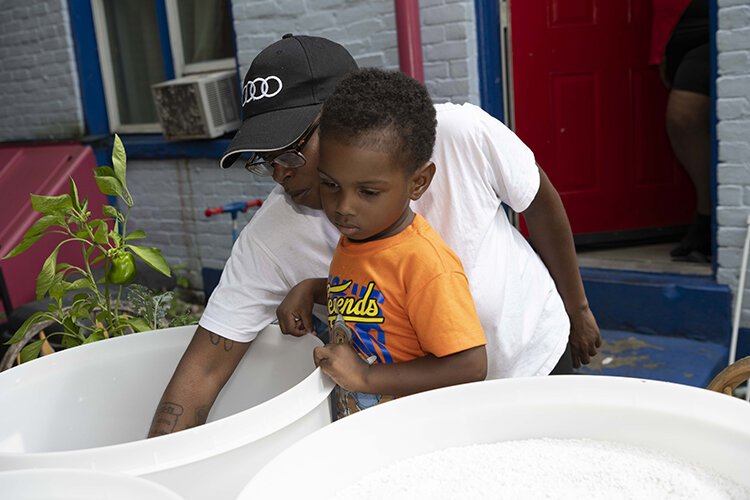 Eboni Sheftall prepares a starter kit for planting at her North Fairmount home.