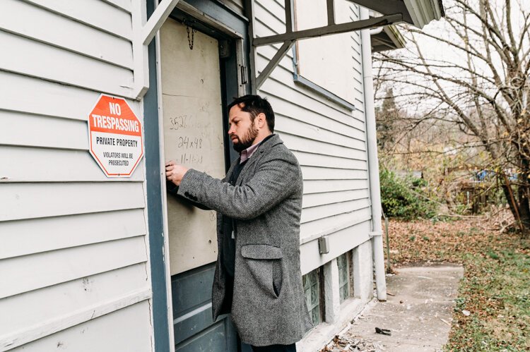 Andrew Fisher of The Port inspects one of the agency-owned houses in East Price Hill. 