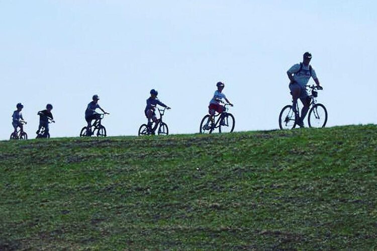 The upper, paved portion of the trail runs atop a floodwall.