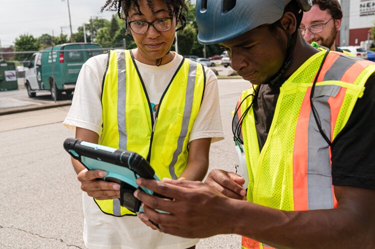 Jaedyah Edwards and Isaiah Robinson check the air quality data the team gathered.